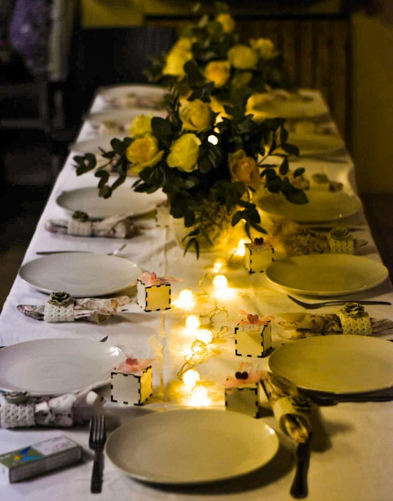 yellow flowers on white ceramic plate on table