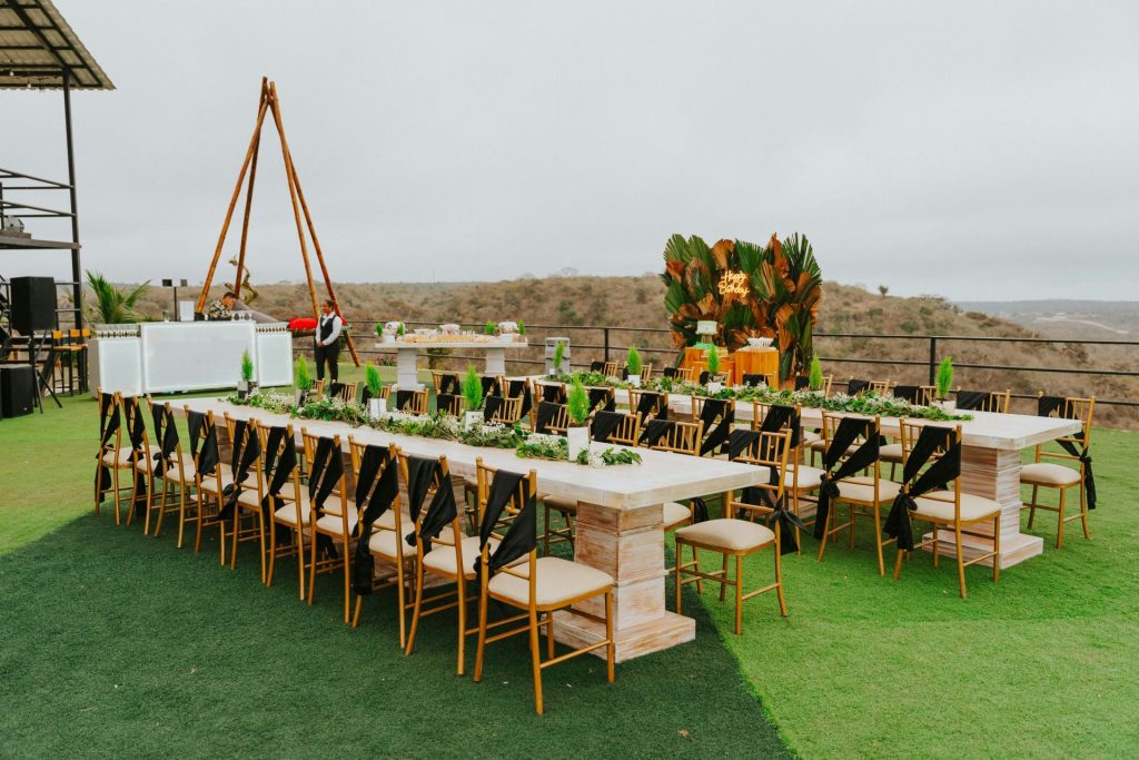 Long dining tables set for an outdoor event